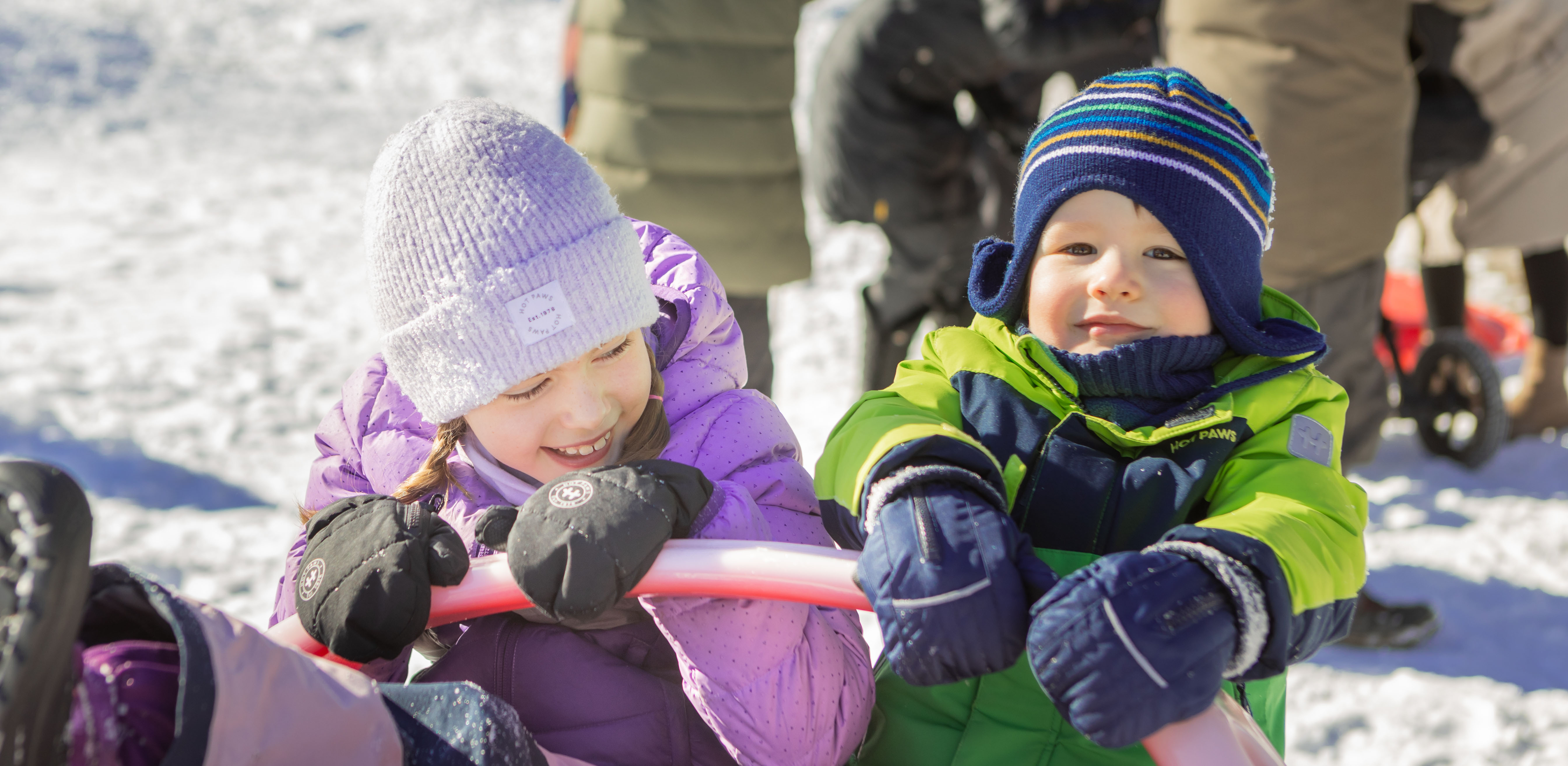 Kids in cozy fall jackets near a lake